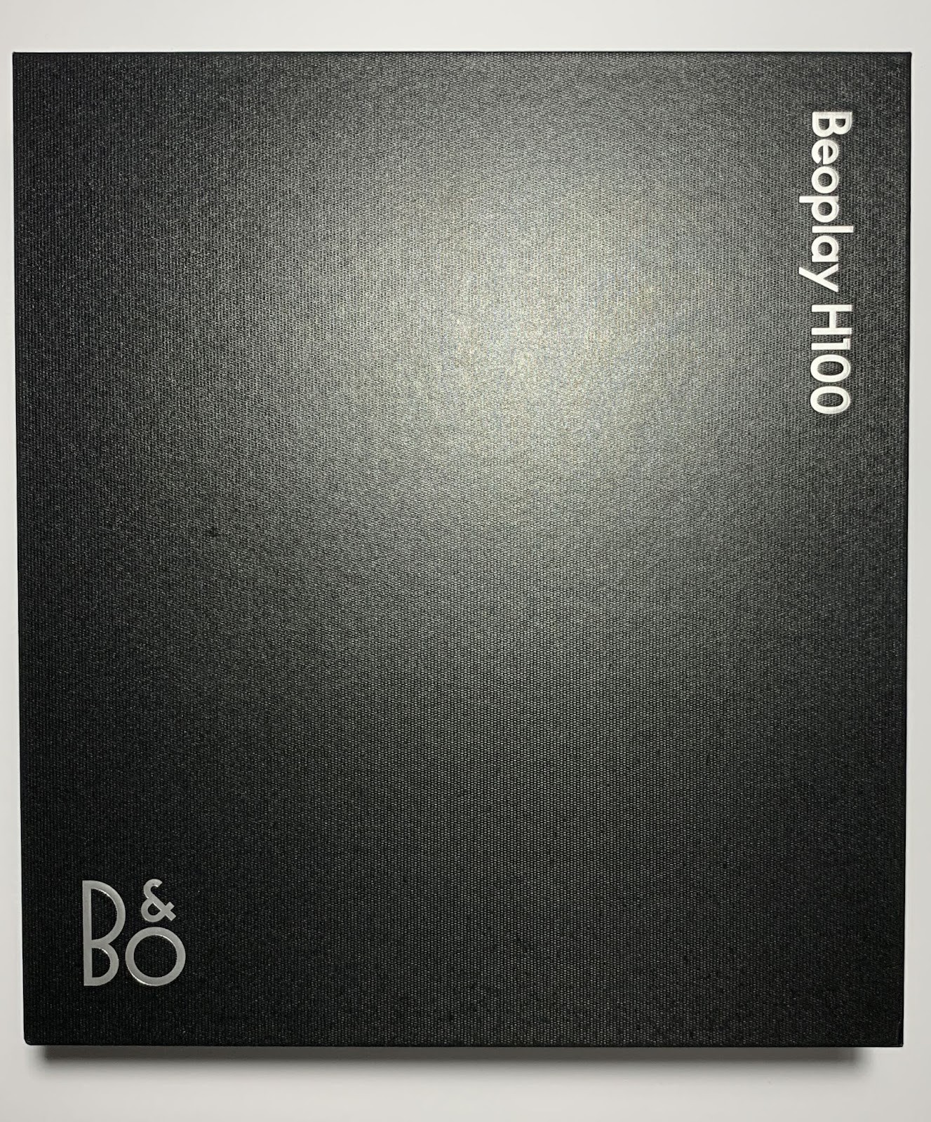 Beoplay H100 Review: Is Bang & Olufsen’s Flagship Worth the Price? 8 The headphones come in a rectangular box made of sturdy black cardboard with a textured finish.